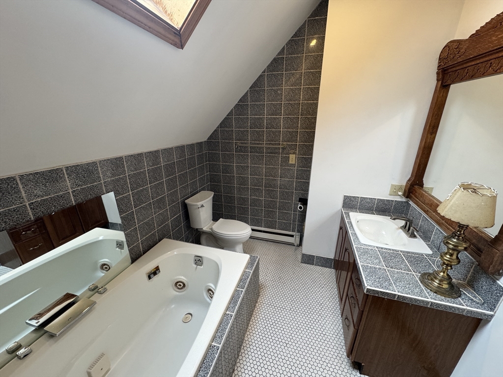 82 Hammond Street, Unit 3 Cambridge, MA 02138 - Photo 11 of 13 a bathroom with a sink and a mirror