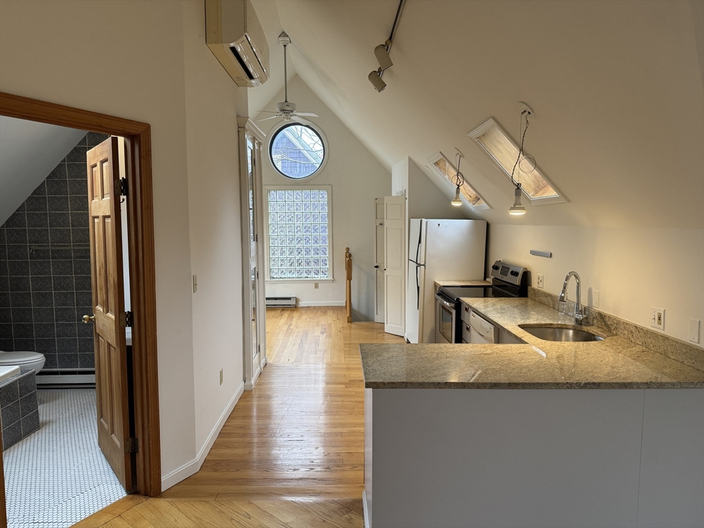82 Hammond Street, Unit 3 Cambridge, MA 02138 - Photo 2 of 13 a view of a kitchen with a sink and dishwasher