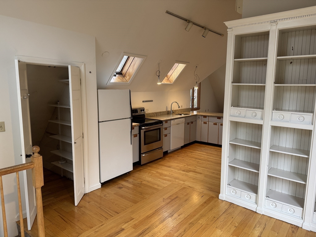 82 Hammond Street, Unit 3 Cambridge, MA 02138 - Photo 8 of 13 a kitchen with stainless steel appliances granite countertop a refrigerator and a stove top oven