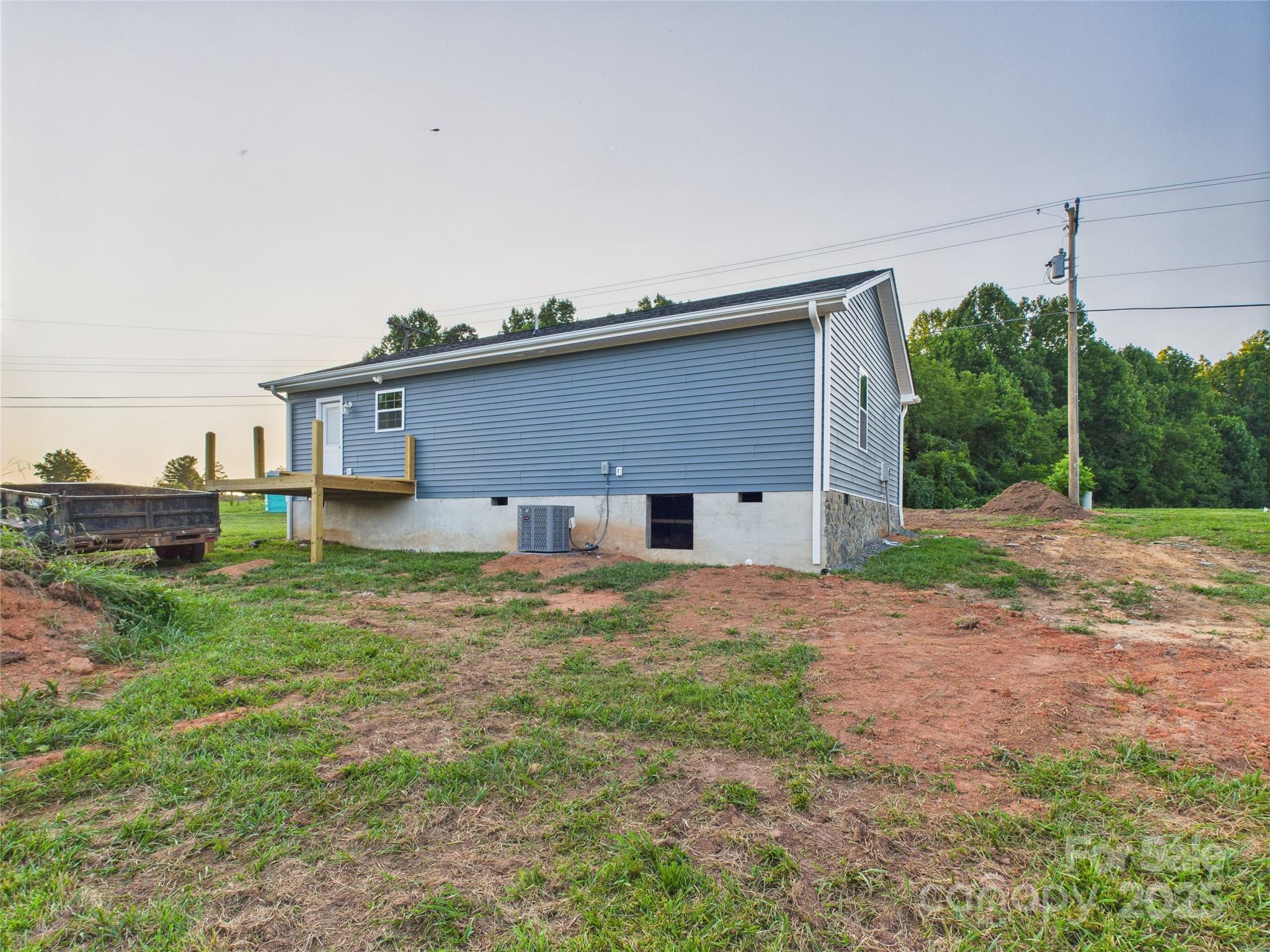 269 Pleasant Hill Road Hudson, NC 28638 - Photo 7 of 10 a backyard of a house with plants and wooden fence