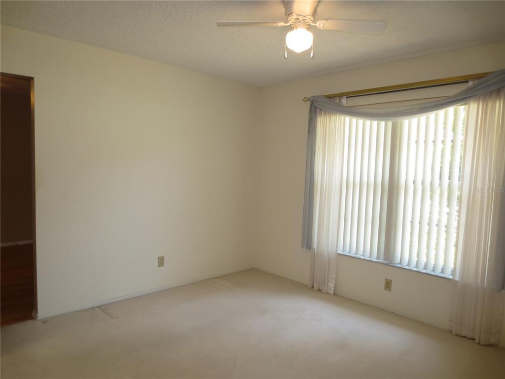 3235 East Dorchester Drive Palm Harbor, FL 34684 - Photo 13 of 47 a view of an empty room with a window
