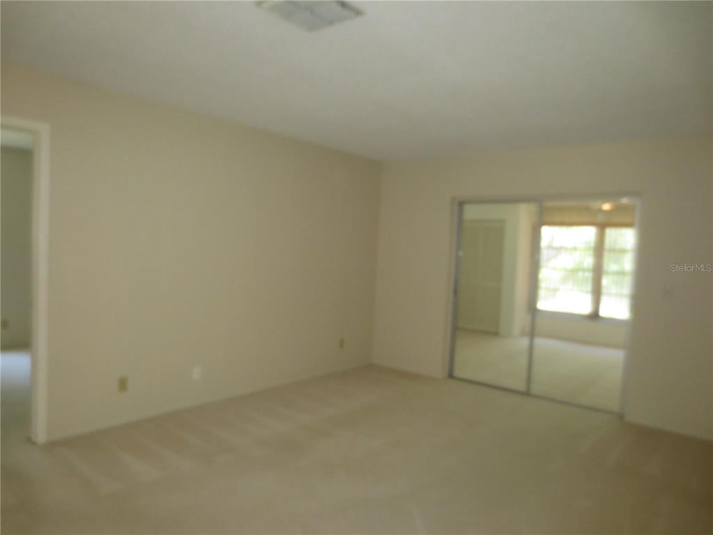 3235 East Dorchester Drive Palm Harbor, FL 34684 - Photo 15 of 47 an empty room with a empty space and windows