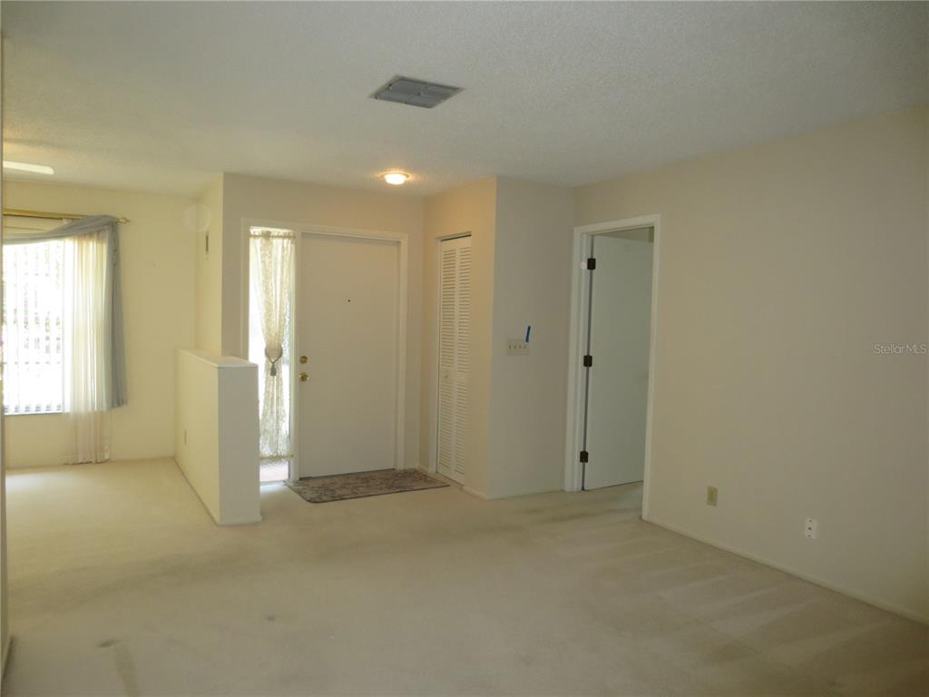 3235 East Dorchester Drive Palm Harbor, FL 34684 - Photo 16 of 47 an empty room with windows and closet