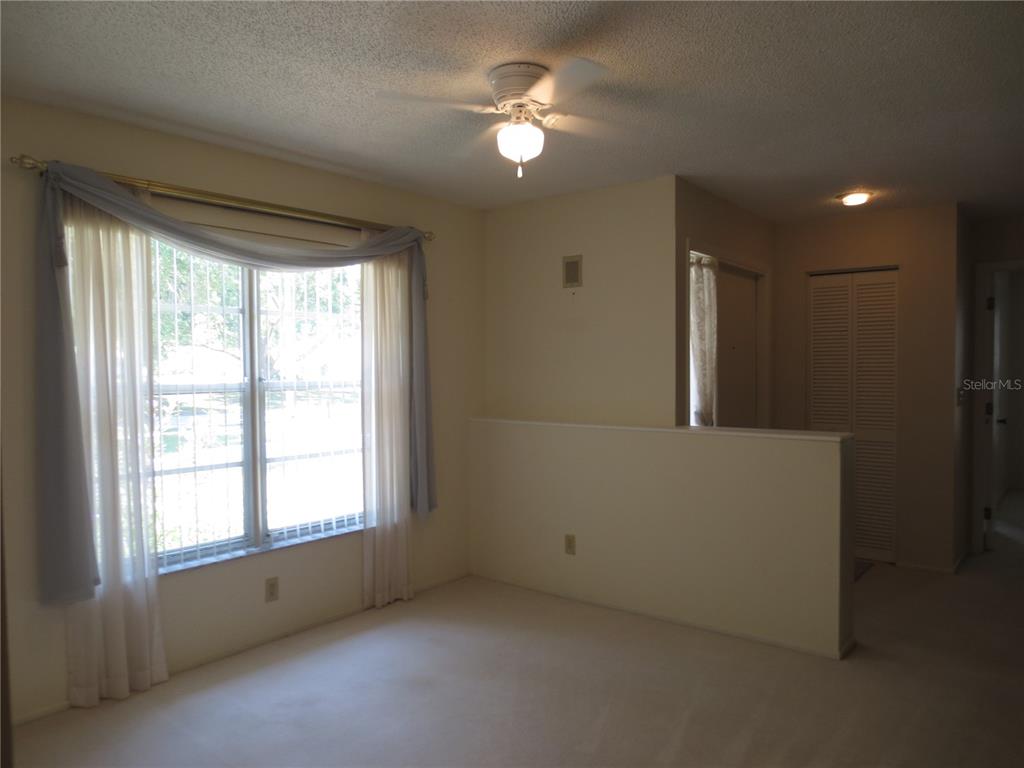 3235 East Dorchester Drive Palm Harbor, FL 34684 - Photo 19 of 47 a view of an empty room with a window