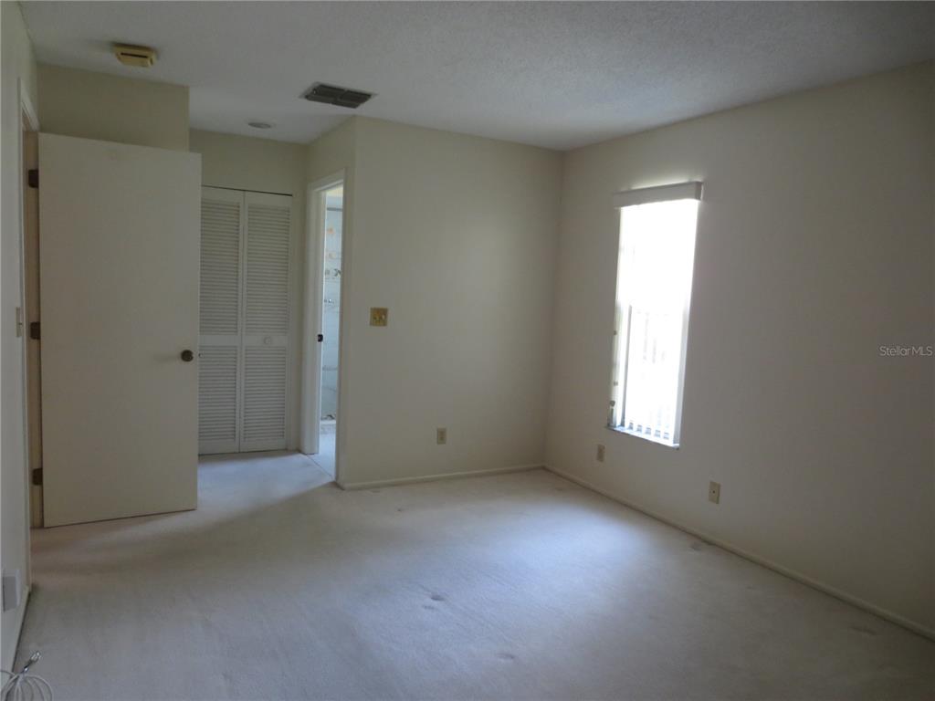 3235 East Dorchester Drive Palm Harbor, FL 34684 - Photo 27 of 47 a view of an empty room with a window