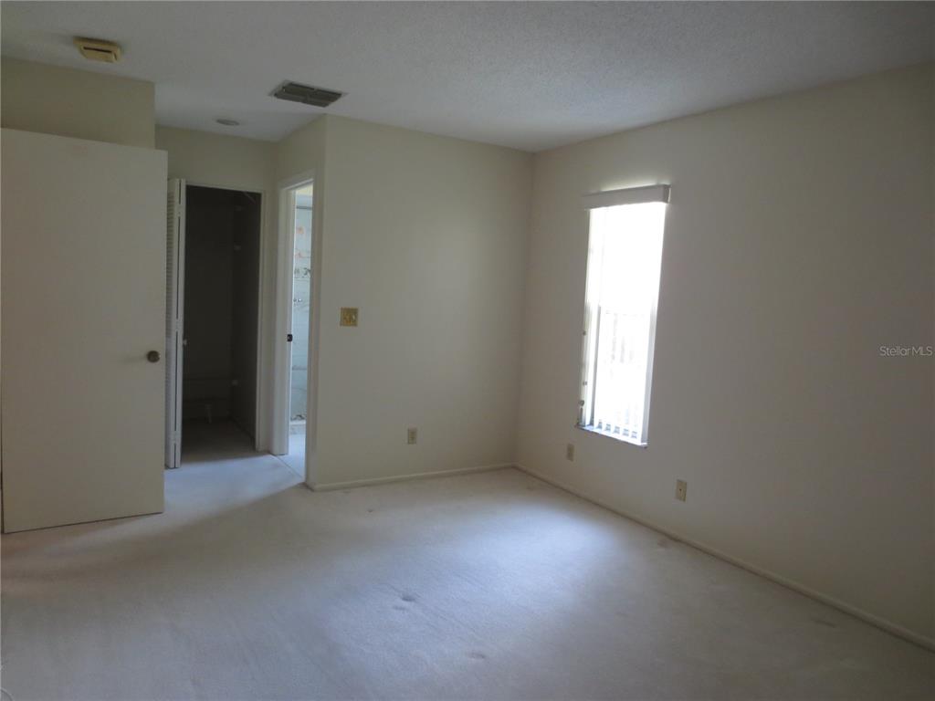 3235 East Dorchester Drive Palm Harbor, FL 34684 - Photo 29 of 47 a view of an empty room with a window