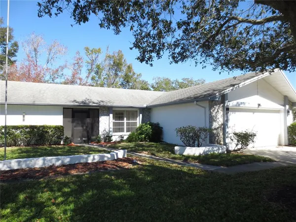 a front view of house with yard and outdoor seating