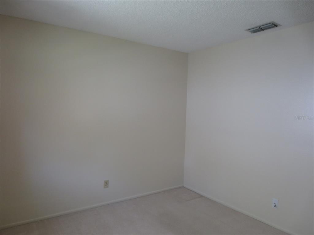 3235 East Dorchester Drive Palm Harbor, FL 34684 - Photo 39 of 47 a room that has a white bench