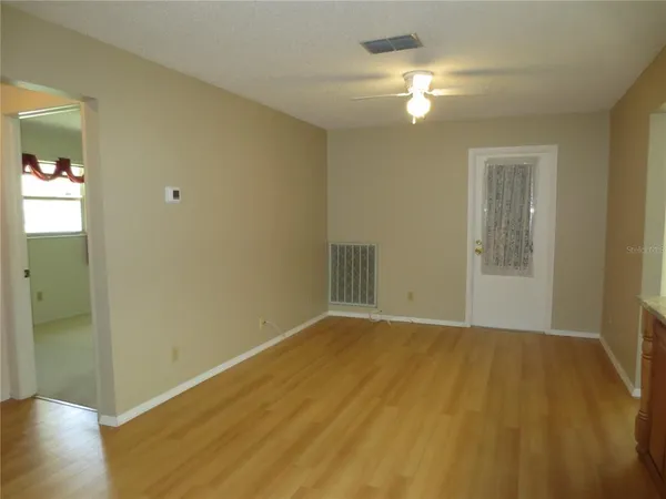a view of an empty room and wooden floor
