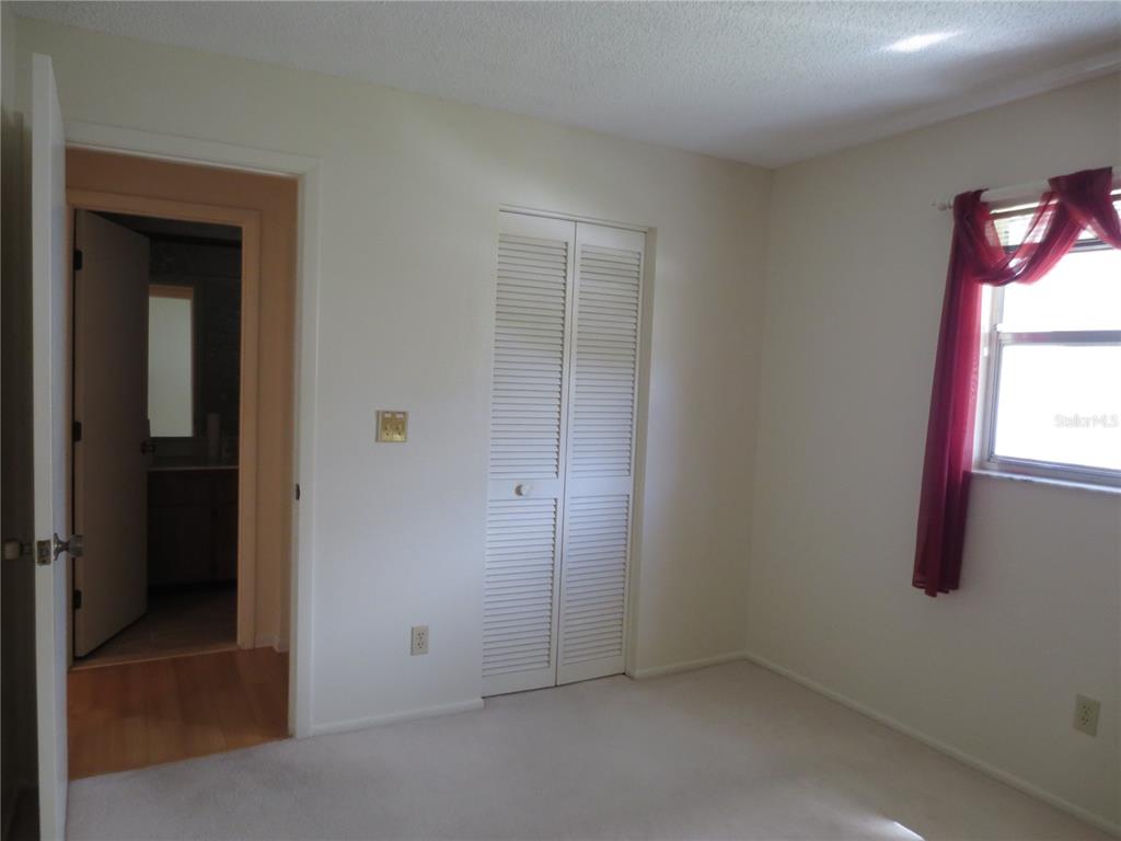 3235 East Dorchester Drive Palm Harbor, FL 34684 - Photo 41 of 47 an empty room with windows and closet