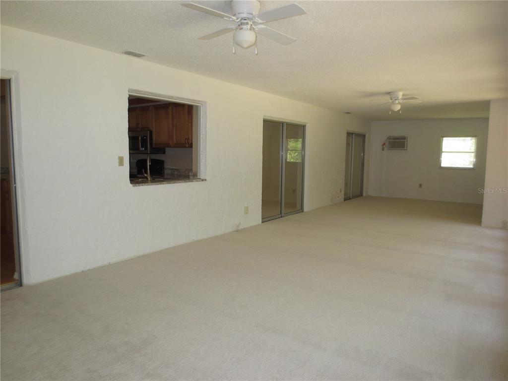 3235 East Dorchester Drive Palm Harbor, FL 34684 - Photo 5 of 47 a view of an empty room with a window