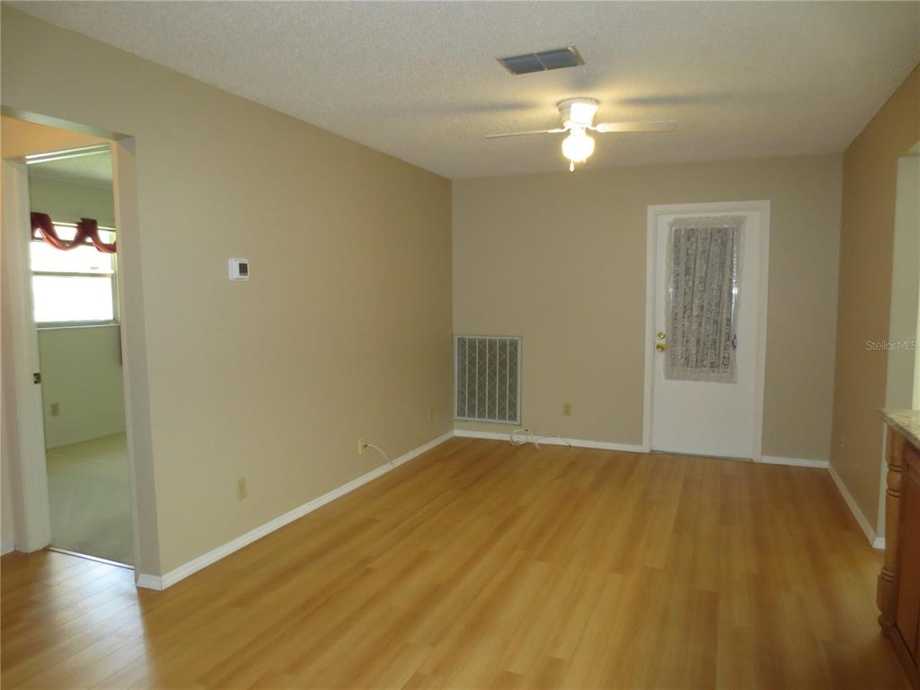 3235 East Dorchester Drive Palm Harbor, FL 34684 - Photo 7 of 47 a view of an empty room and wooden floor