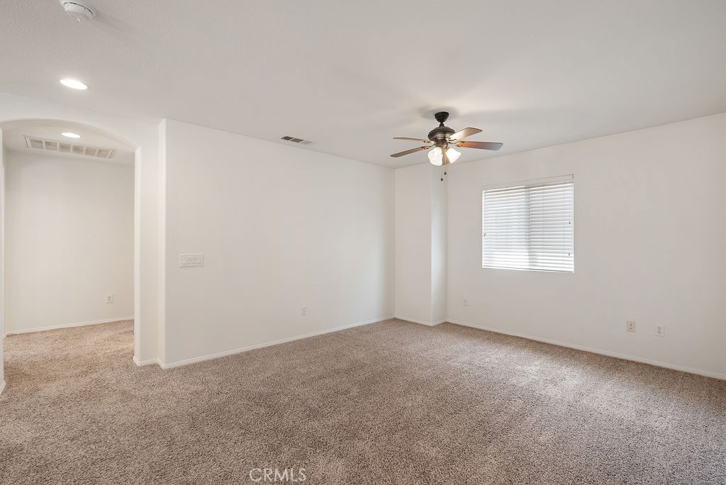 27635 Sienna Rdg Row Canyon Country, CA 91351 - Photo 14 of 30 a view of an empty room with a ceiling fan and a window