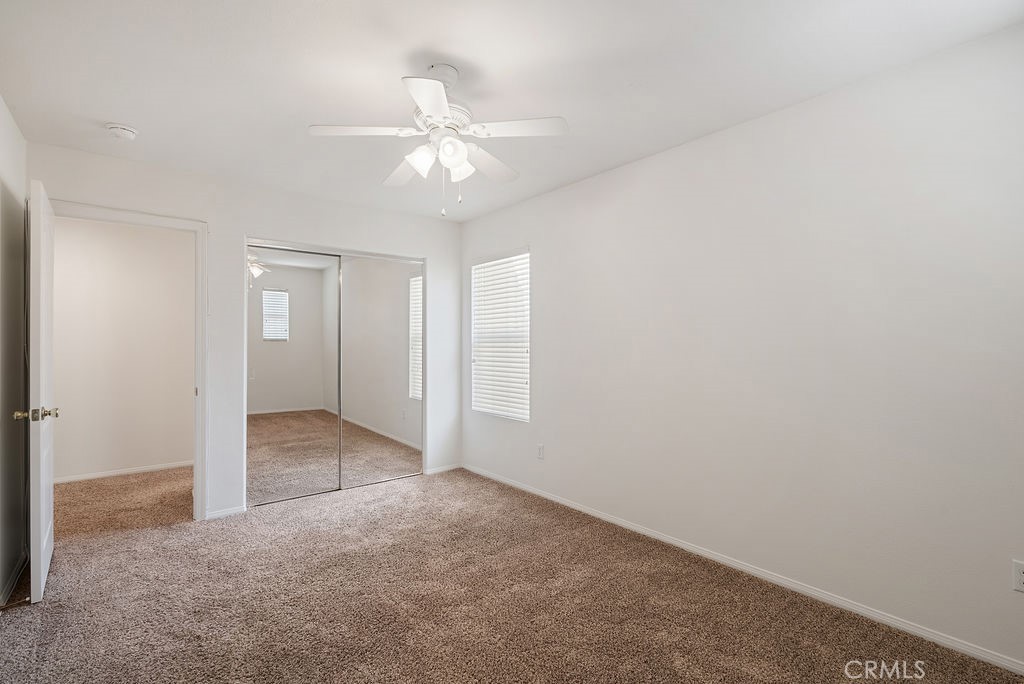 27635 Sienna Rdg Row Canyon Country, CA 91351 - Photo 18 of 30 a view of an empty room with a chandelier fan
