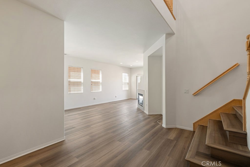 27635 Sienna Rdg Row Canyon Country, CA 91351 - Photo 4 of 30 a view of an empty room with wooden floor and stairs