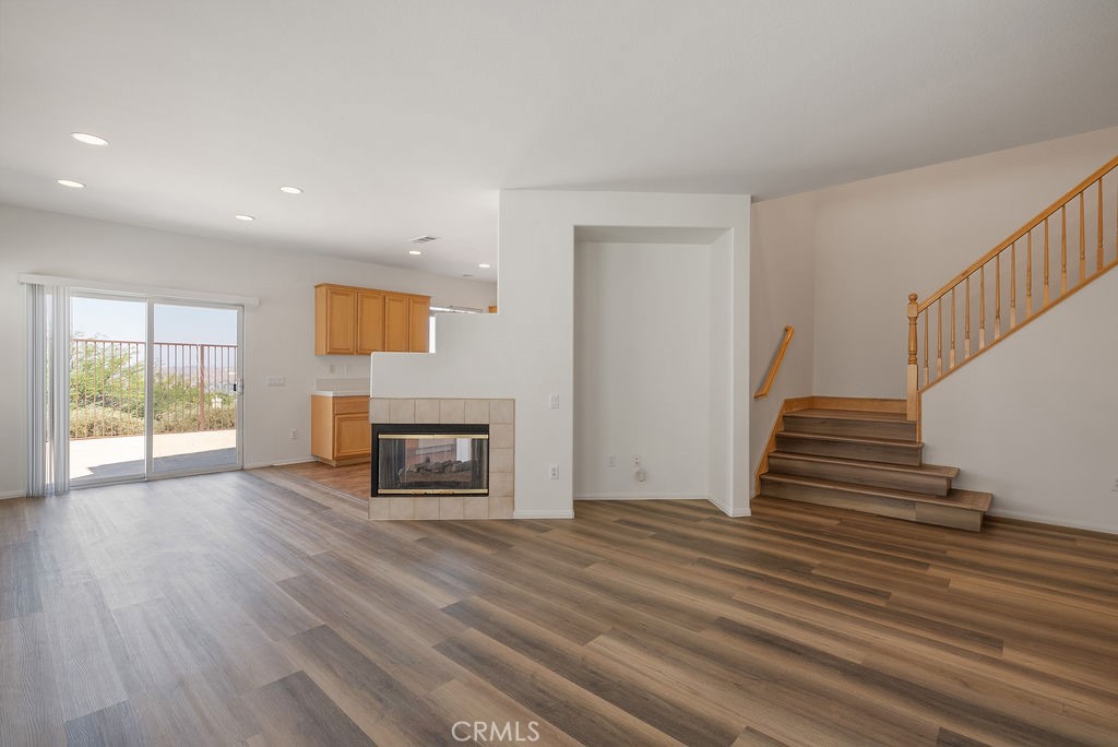 27635 Sienna Rdg Row Canyon Country, CA 91351 - Photo 5 of 30 a view of a livingroom with wooden floor and a fireplace