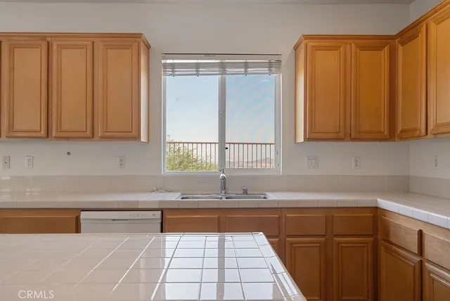 a kitchen with granite countertop a sink and cabinets