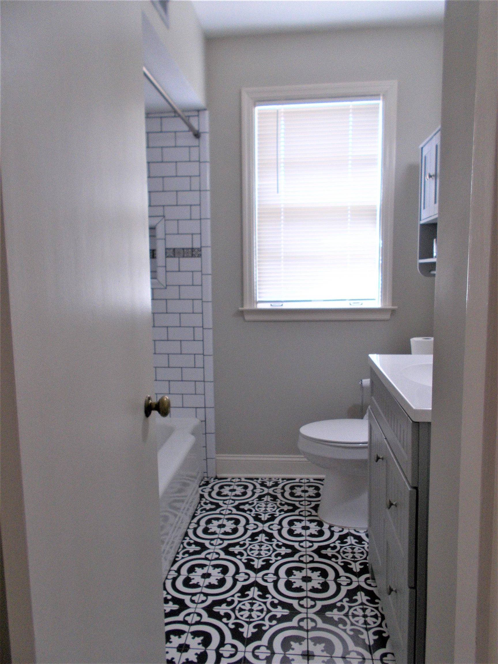 1061 Wingfield Road Memphis, TN 38122 - Photo 19 of 25 a bathroom with a toilet a window and a shower