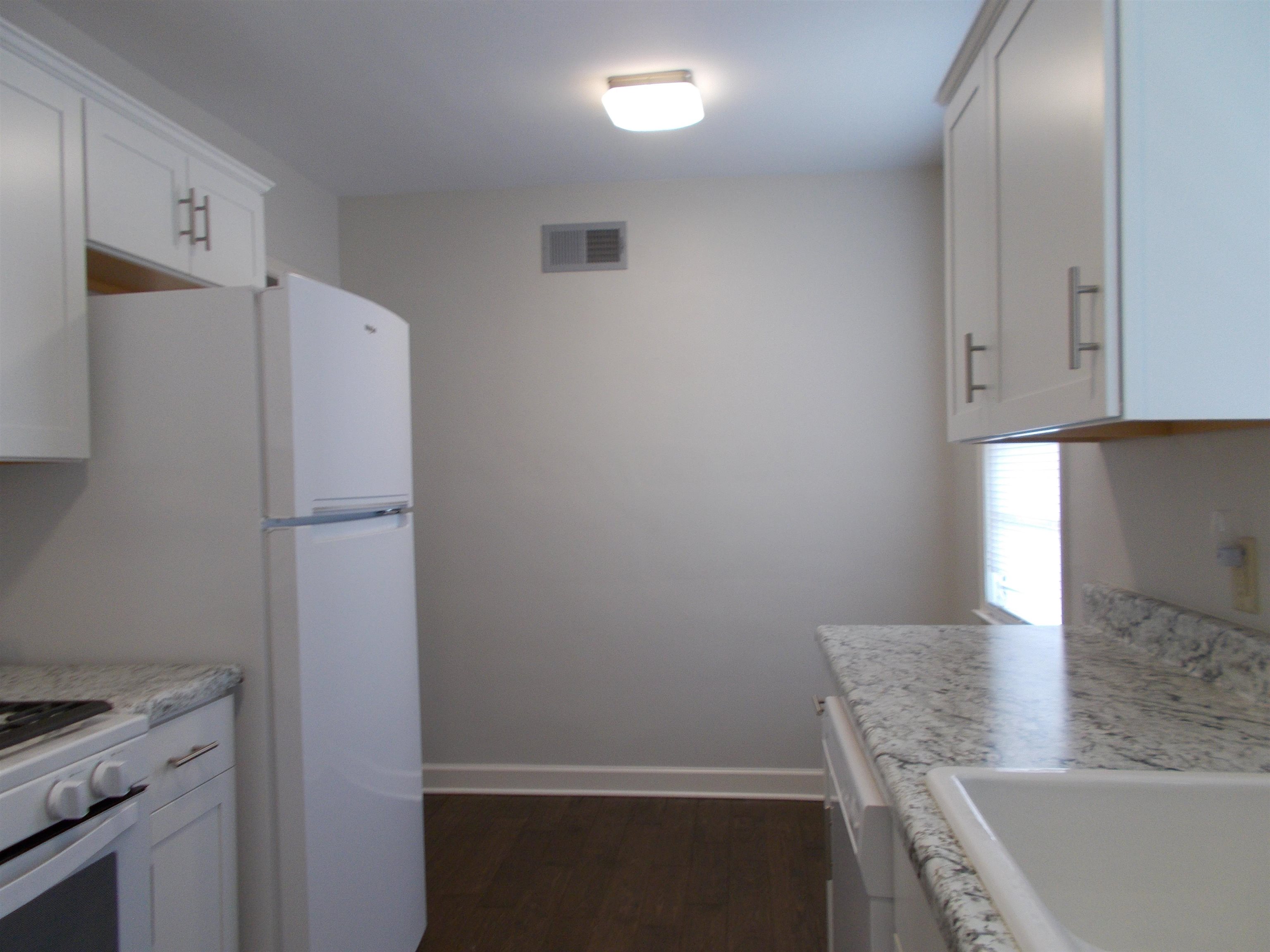 1061 Wingfield Road Memphis, TN 38122 - Photo 6 of 25 a kitchen with a refrigerator and a stove top oven