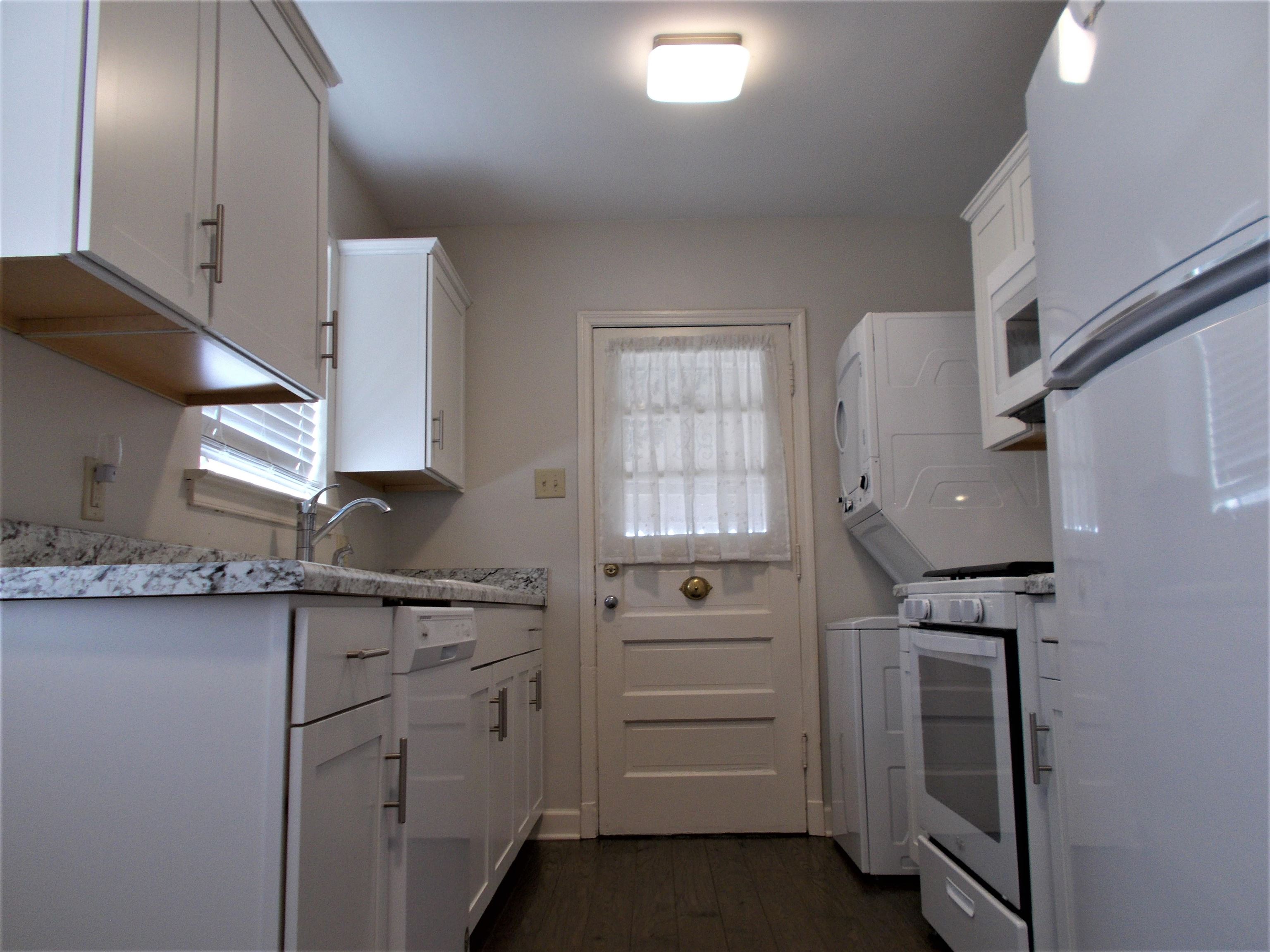 1061 Wingfield Road Memphis, TN 38122 - Photo 8 of 25 a kitchen with white cabinets and appliances