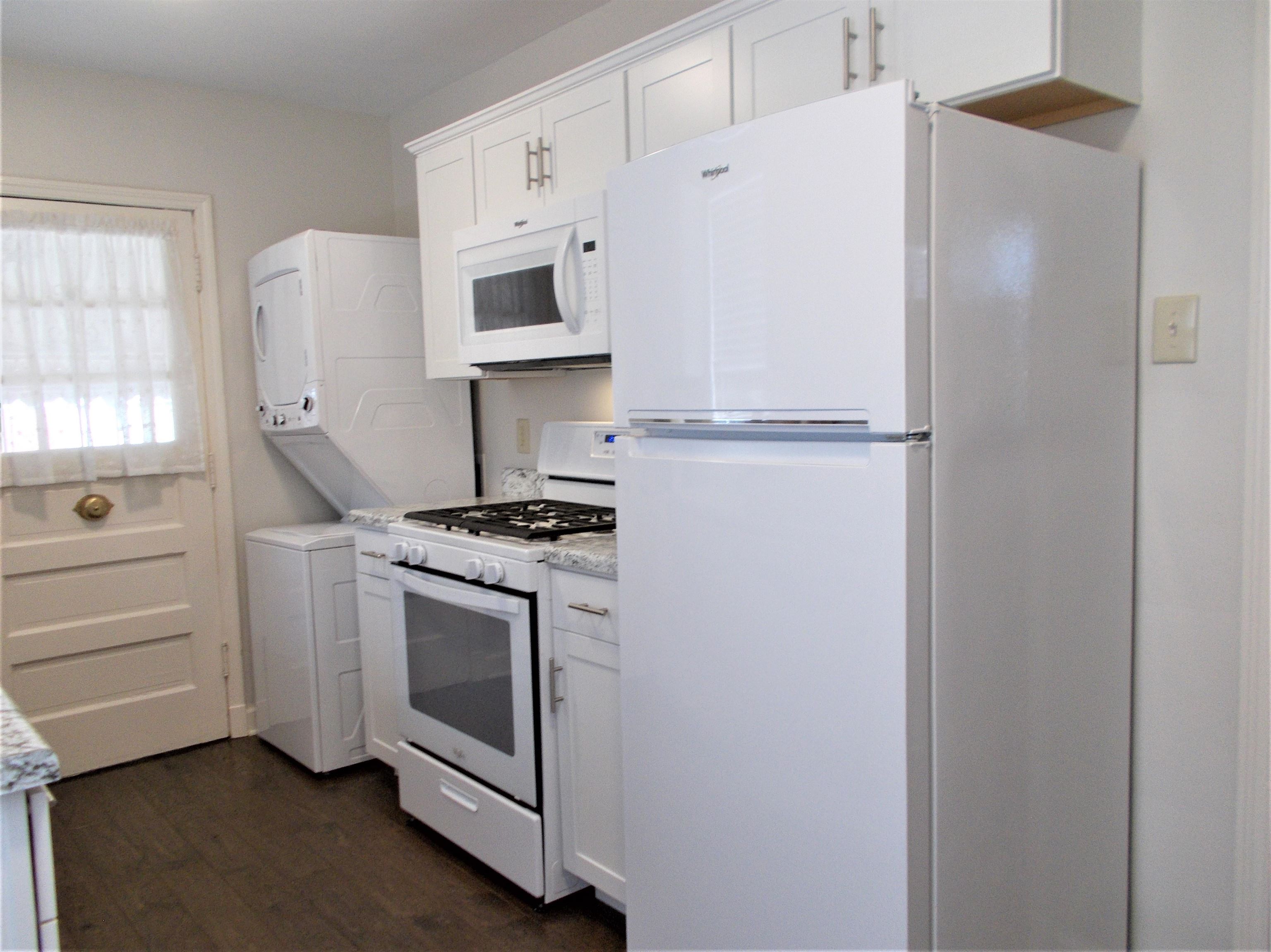 1061 Wingfield Road Memphis, TN 38122 - Photo 9 of 25 a kitchen with white cabinets and white appliances