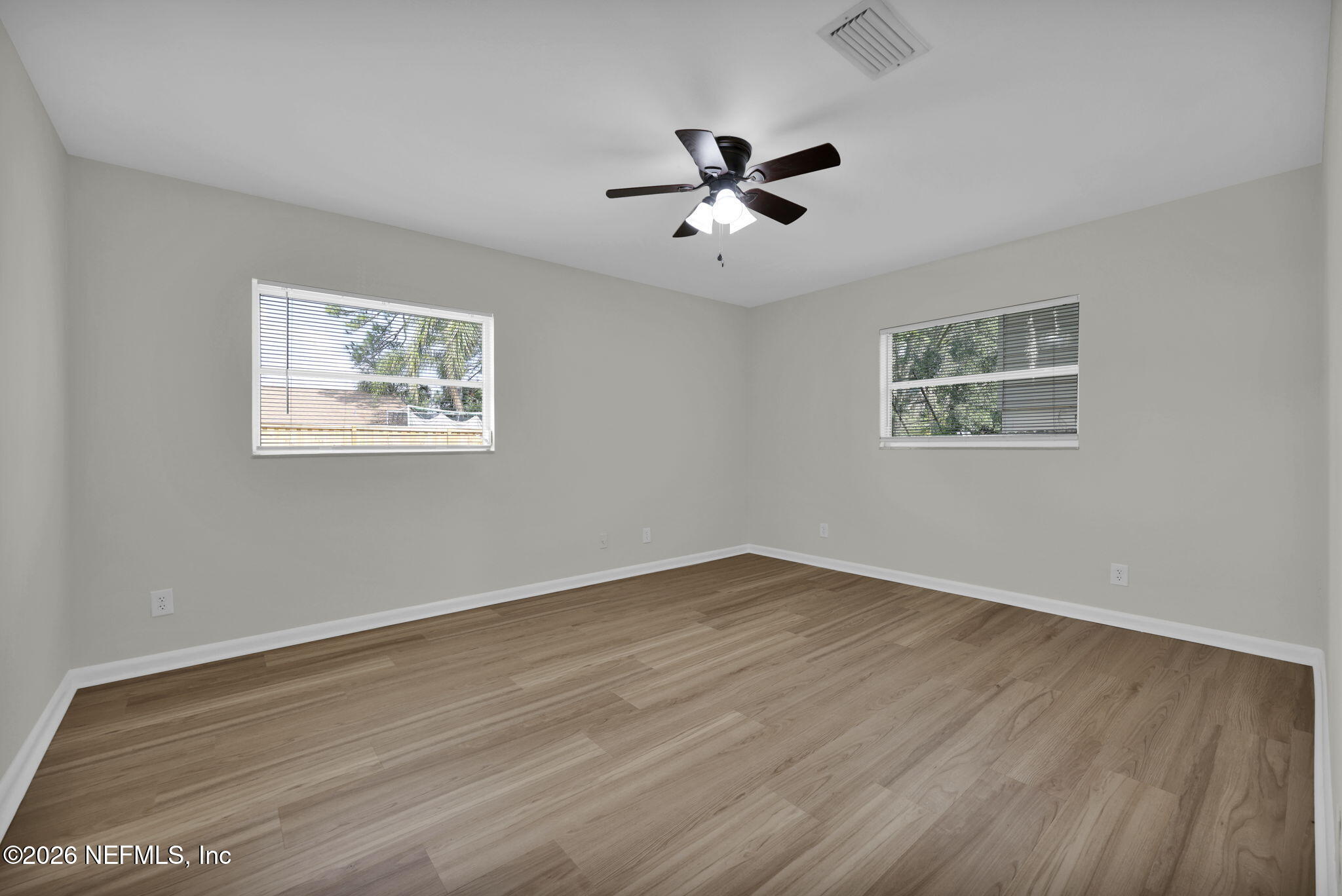 8544 Sanchez Road Jacksonville, FL 32217 - Photo 33 of 46 a view of an empty room with wooden floor and a ceiling fan