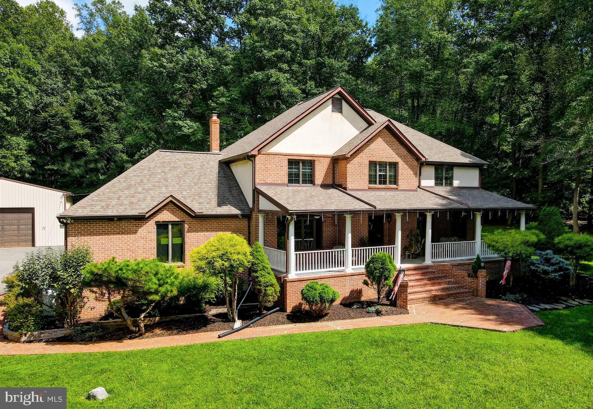 2021 Oakmont Road Fallston, MD 21047 - Photo 1 of 50 a front view of a house with a yard and green space