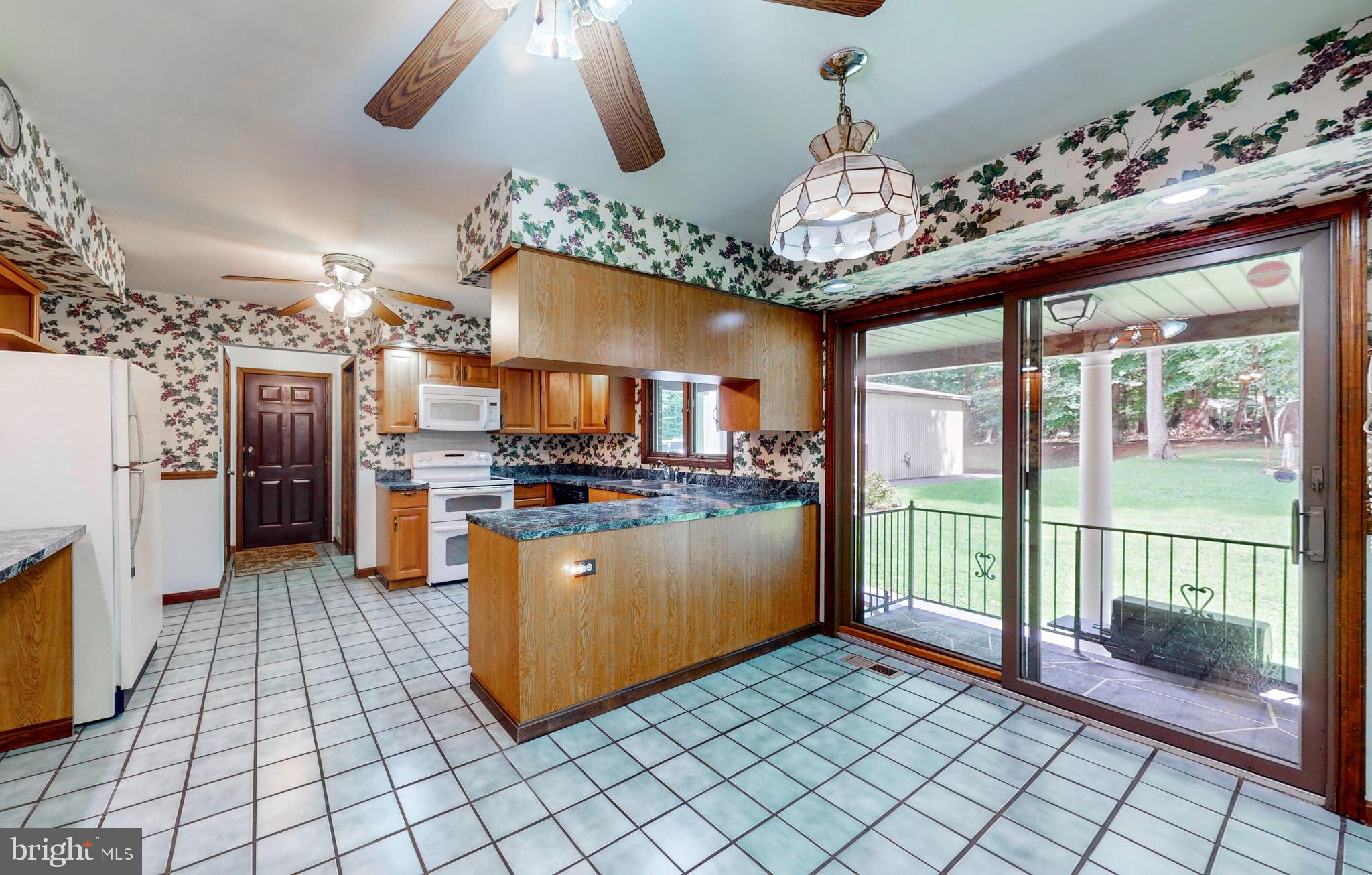 2021 Oakmont Road Fallston, MD 21047 - Photo 16 of 50 a kitchen with stainless steel appliances granite countertop a refrigerator a oven a sink and a dining table