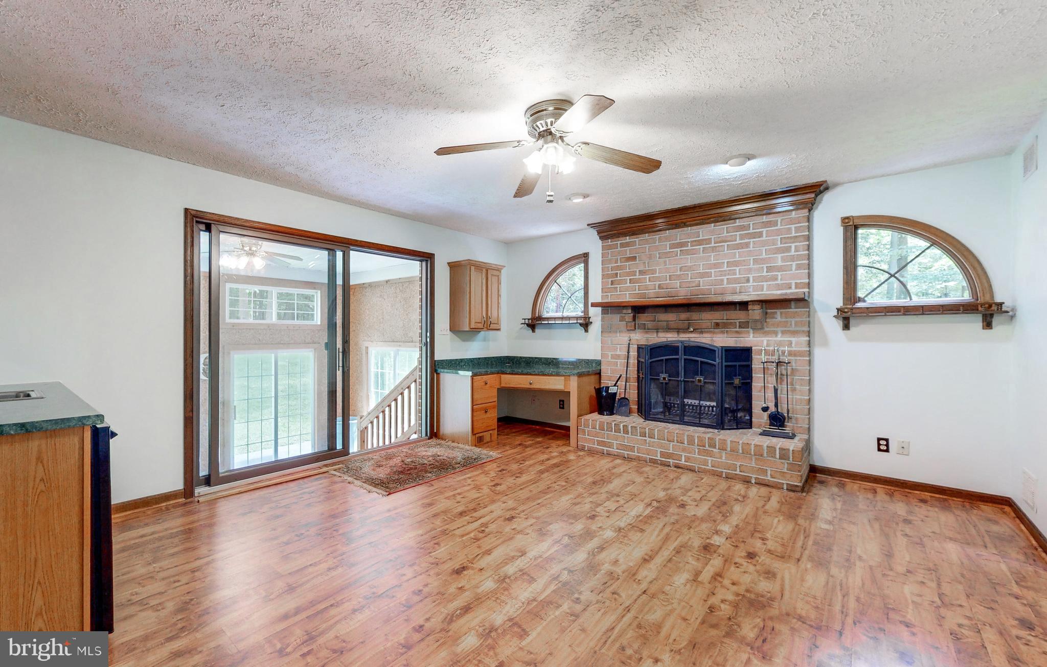 2021 Oakmont Road Fallston, MD 21047 - Photo 17 of 50 an empty room with windows fireplace and fan