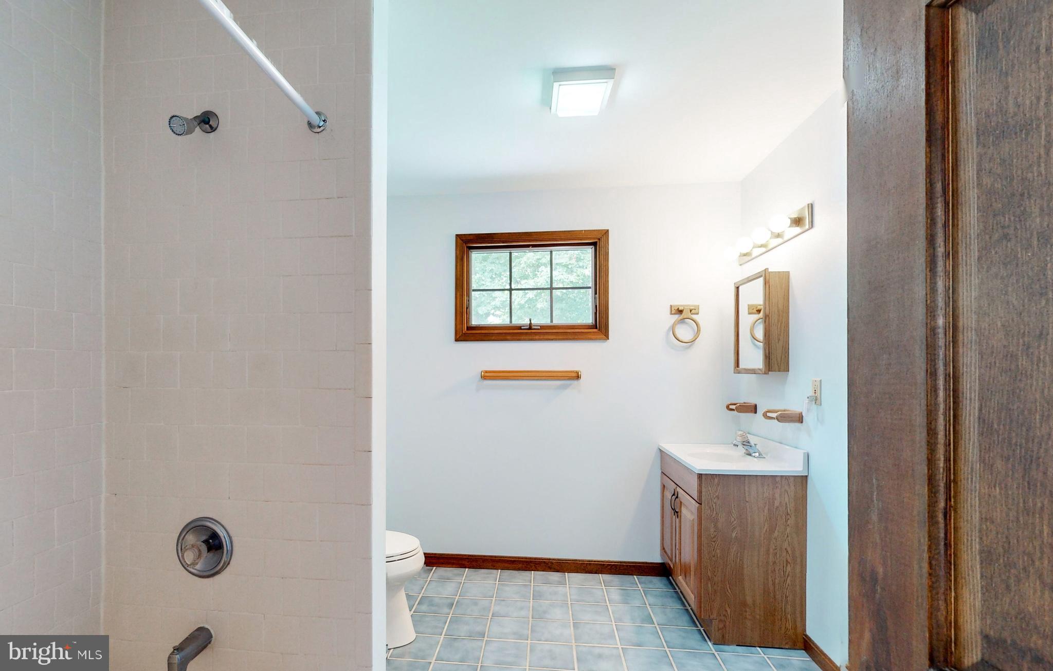 2021 Oakmont Road Fallston, MD 21047 - Photo 28 of 50 a bathroom with a sink mirror and tub