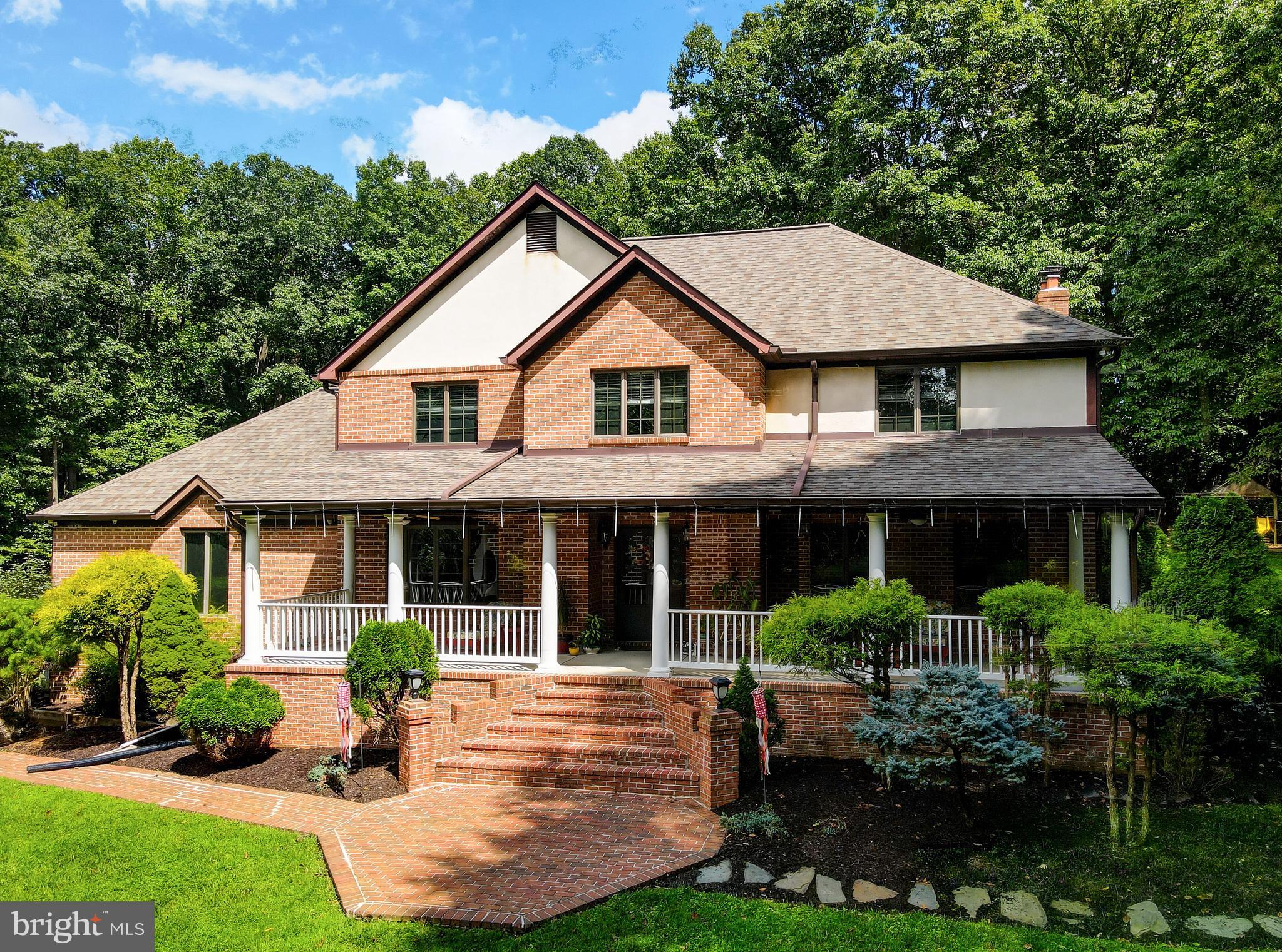 2021 Oakmont Road Fallston, MD 21047 - Photo 3 of 50 a front view of a house with a yard and potted plants