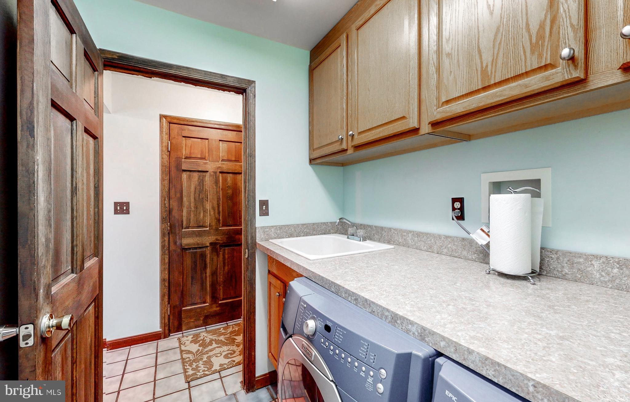 2021 Oakmont Road Fallston, MD 21047 - Photo 32 of 50 a kitchen with granite countertop a sink a stove and refrigerator