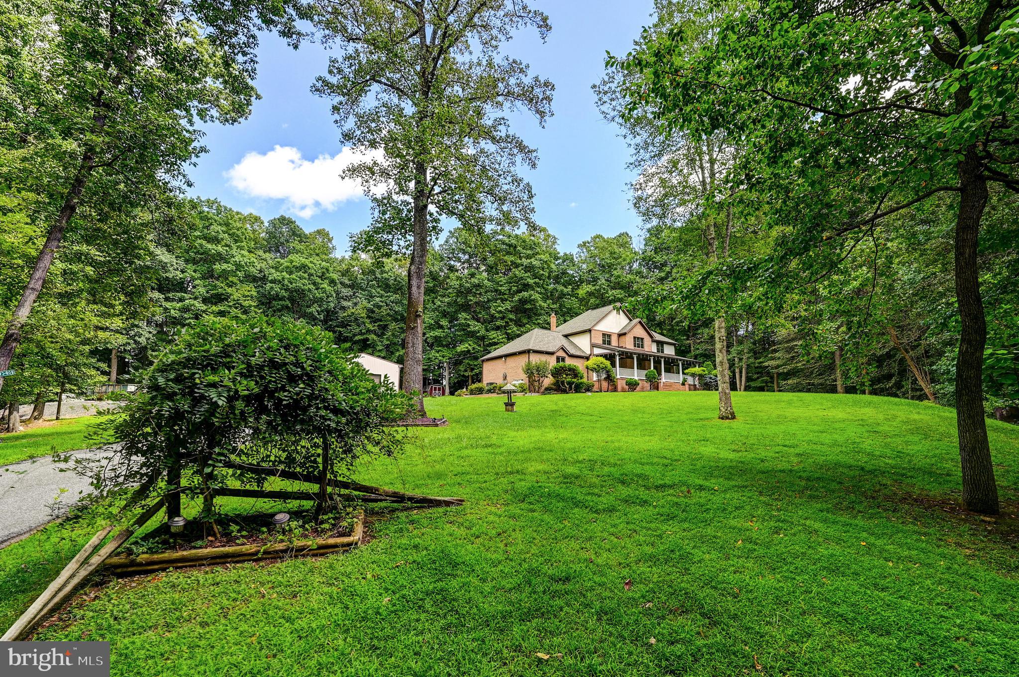2021 Oakmont Road Fallston, MD 21047 - Photo 49 of 50 a view of a backyard with table and chairs plants and large trees