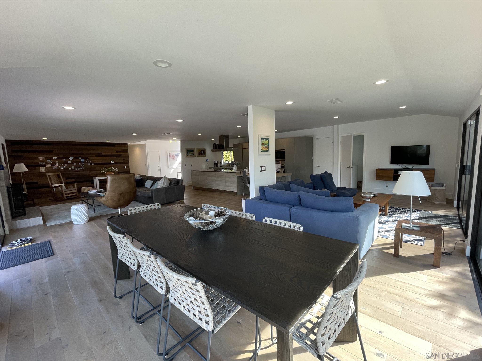 1402 Rodeo Drive La Jolla, CA 92037 - Photo 25 of 42 a living room with furniture a table and kitchen view