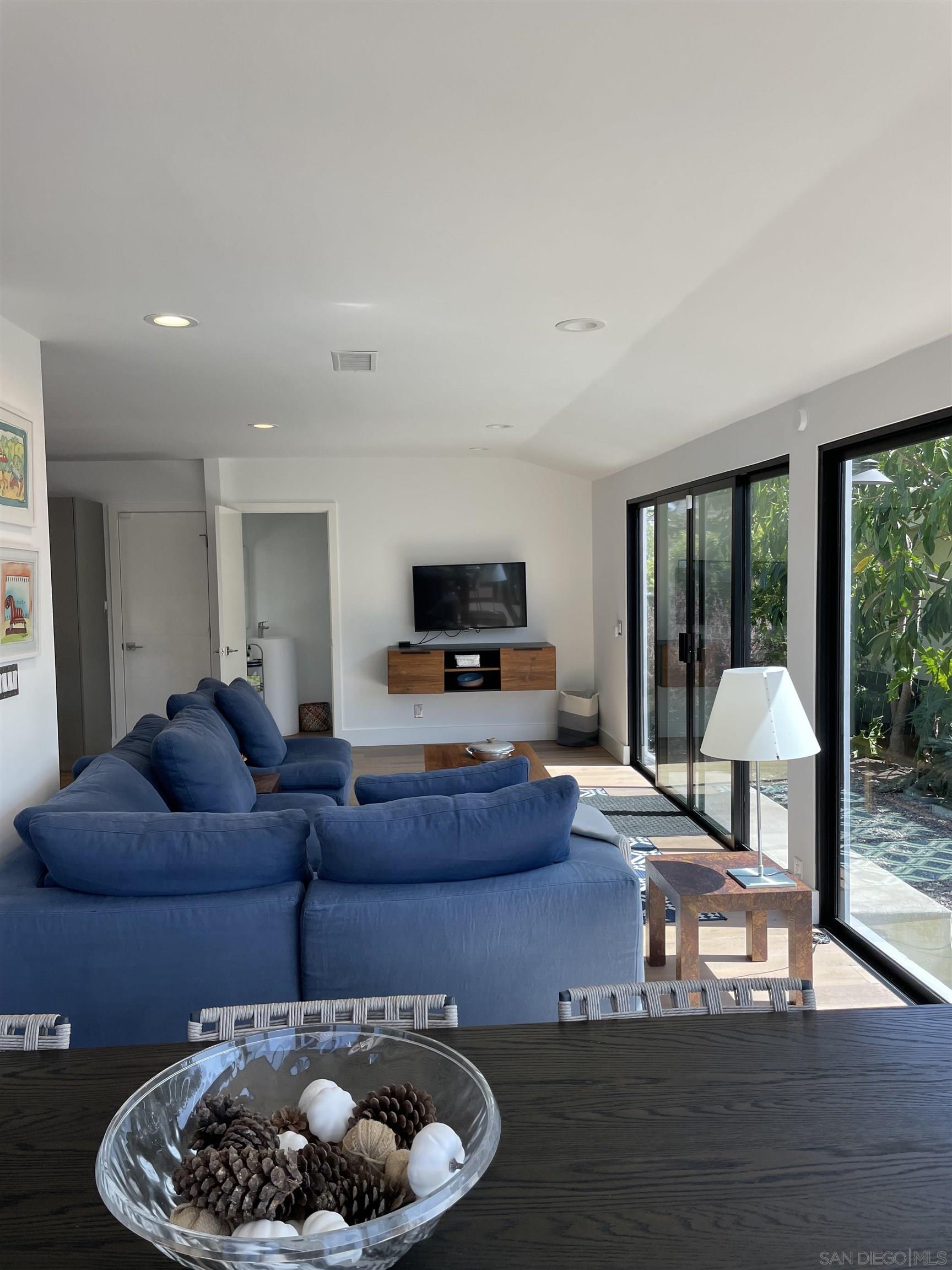 1402 Rodeo Drive La Jolla, CA 92037 - Photo 38 of 42 a living room with furniture and a floor to ceiling window