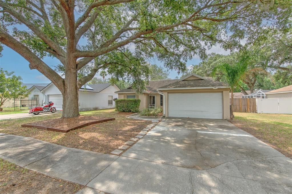 1901 Rudder Drive Valrico, FL 33594 - Photo 1 of 1 a view of a house with a yard and garage