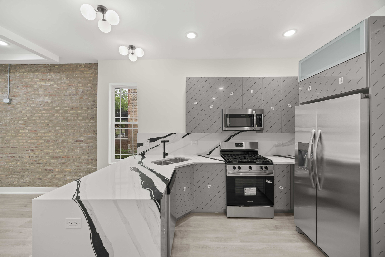 7232 South Union Avenue Chicago, IL 60621 - Photo 3 of 11 a kitchen with stainless steel appliances a refrigerator a sink a stove top oven and cabinets