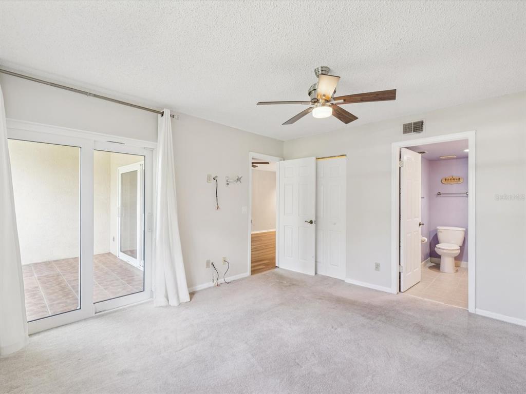 12900 Vonn Road, Unit E203 Largo, FL 33774 - Photo 11 of 26 a view of a room with cabinet and a ceiling fan
