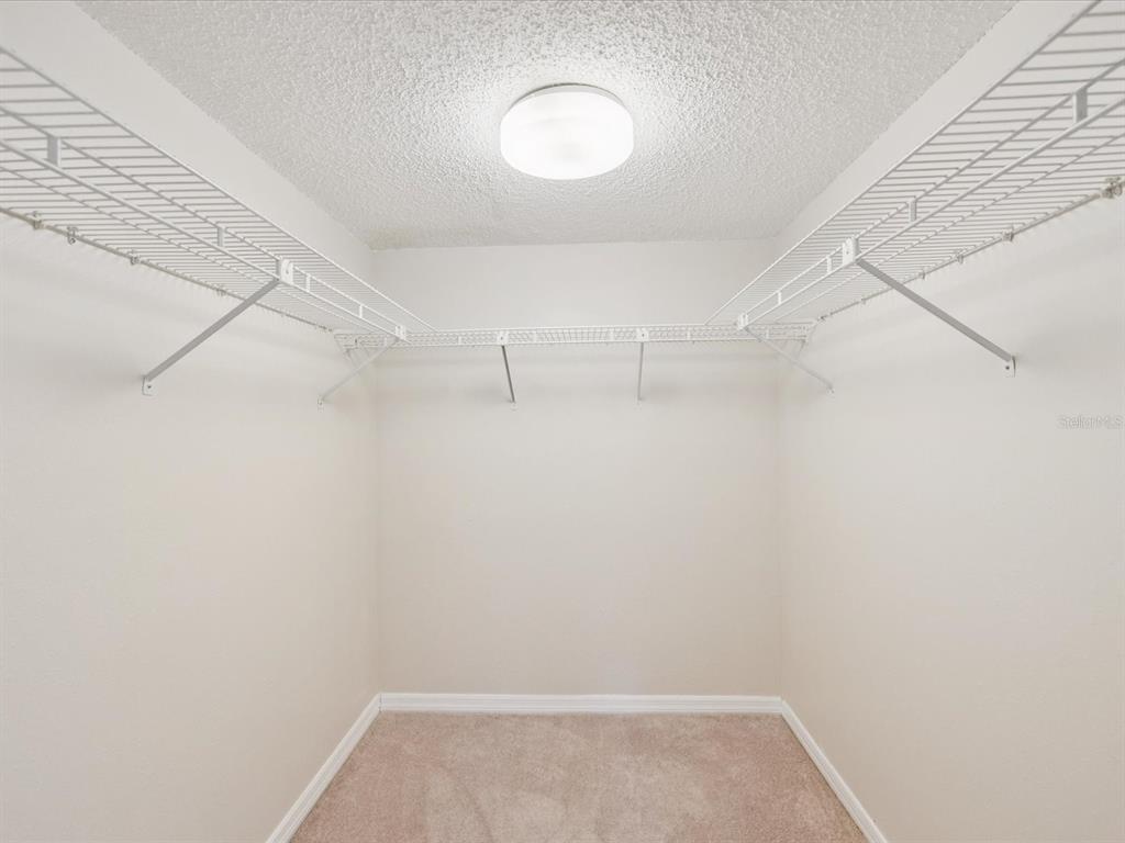 12900 Vonn Road, Unit E203 Largo, FL 33774 - Photo 13 of 26 a view of a room with racks on the wall