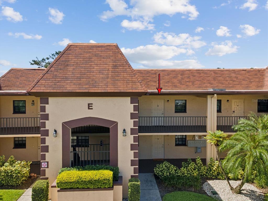 12900 Vonn Road, Unit E203 Largo, FL 33774 - Photo 17 of 26 a front view of a house with garden