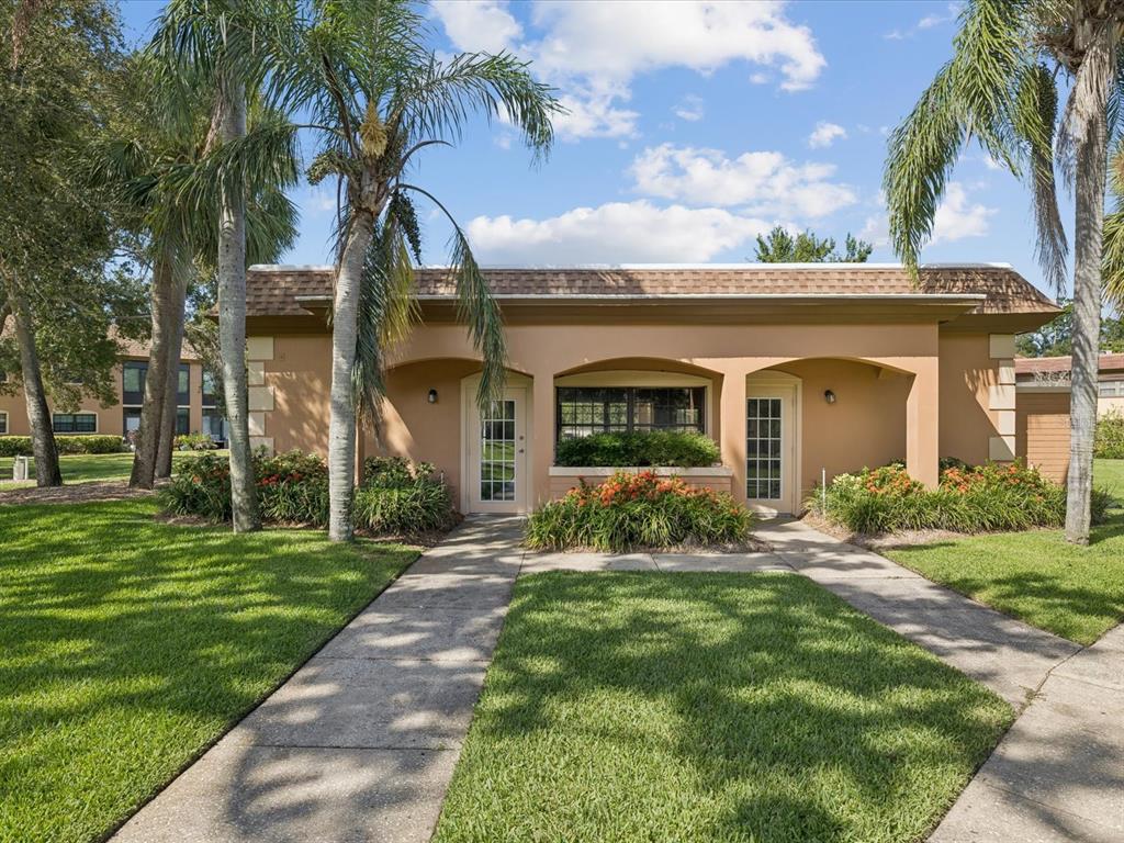 12900 Vonn Road, Unit E203 Largo, FL 33774 - Photo 22 of 26 a front view of a house with garden