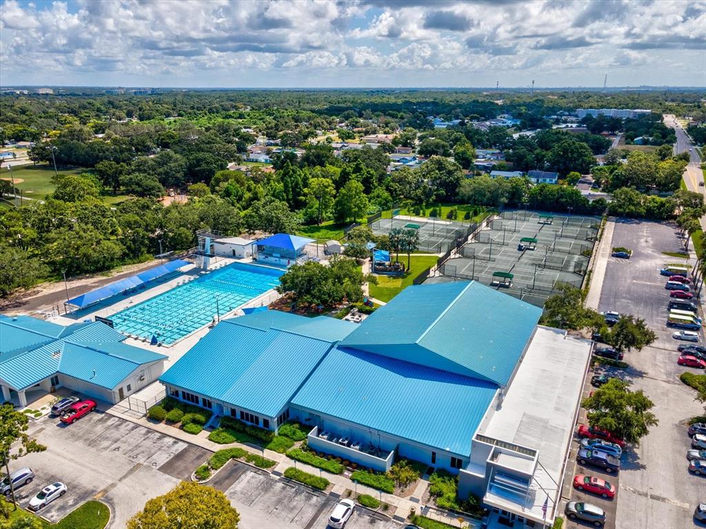 12900 Vonn Road, Unit E203 Largo, FL 33774 - Photo 23 of 26 an aerial view of a tennis ground and a cars park