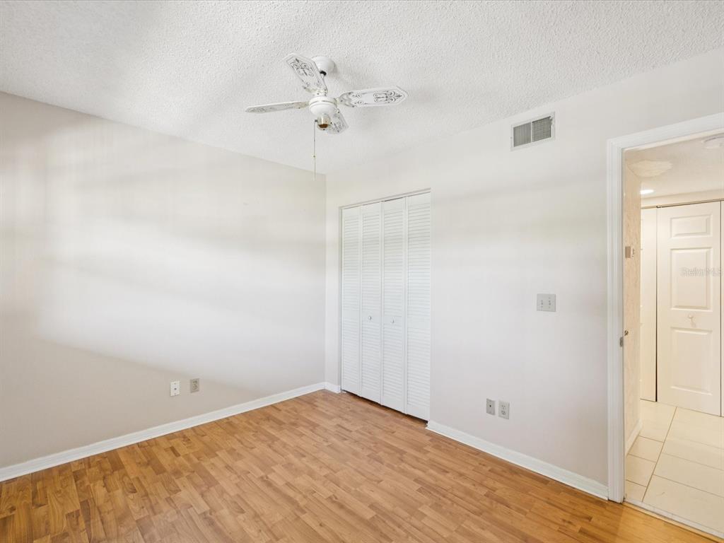 12900 Vonn Road, Unit E203 Largo, FL 33774 - Photo 9 of 26 wooden floor in an empty room