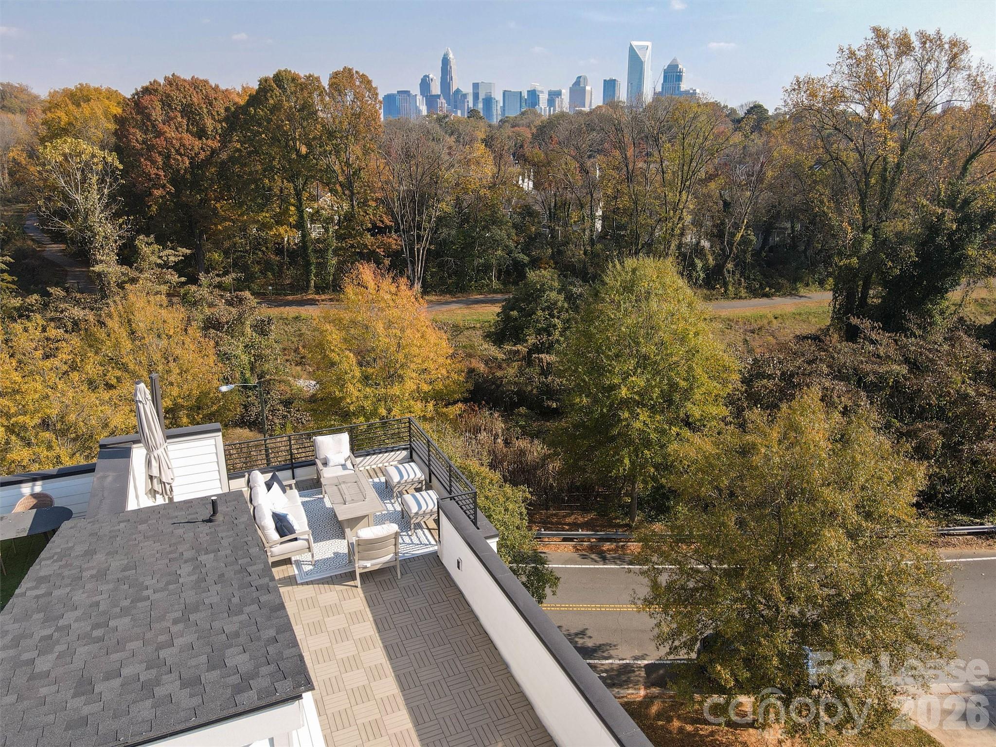 2319 Wesley Village Road Charlotte, NC 28208 - Photo 44 of 44 a view of a terrace with a bench and trees