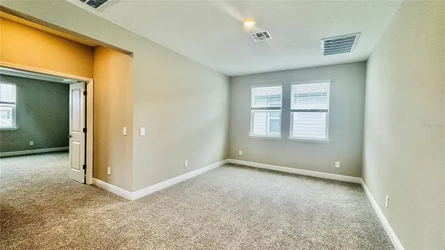 an empty room with a empty space and windows