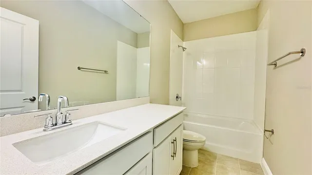 a bathroom with a sink vanity granite tub and shower