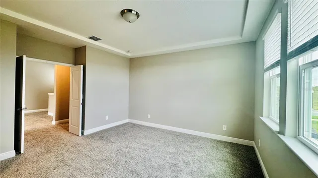 an empty room with windows and closet