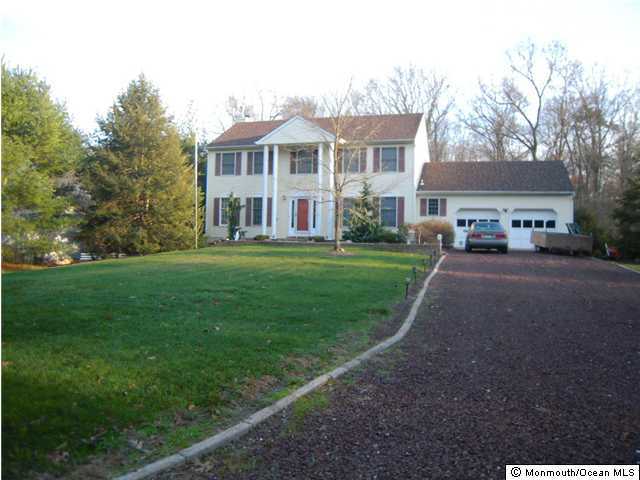 441 Freehold Road Jackson, NJ 08527 - Photo 1 of 3 a front view of a house with a yard and trees
