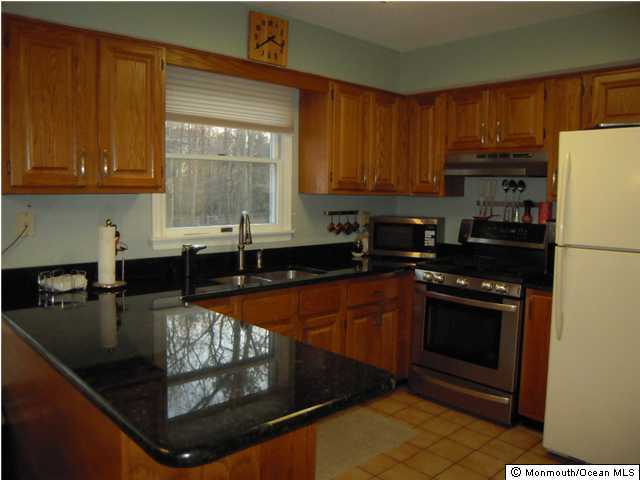 441 Freehold Road Jackson, NJ 08527 - Photo 3 of 3 a kitchen with stainless steel appliances granite countertop a stove a sink and a microwave