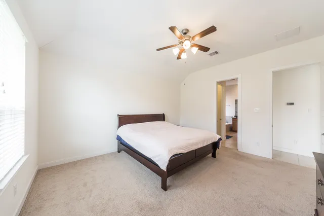 a bedroom with a bed and window